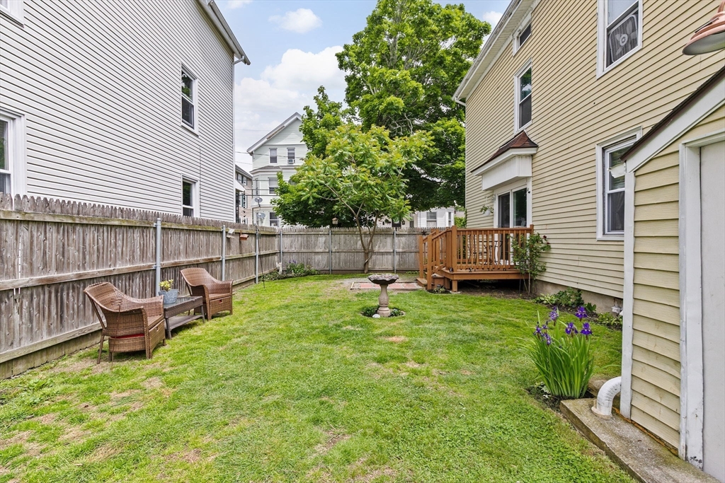 93 Warren Street Fall River, MA 02721 - Photo 31 of 42 a view of backyard with a garden and deck