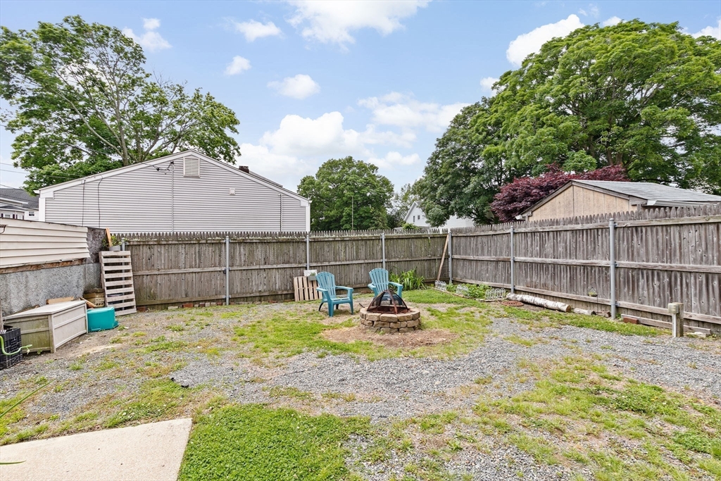 93 Warren Street Fall River, MA 02721 - Photo 33 of 42 a view of a backyard with a small cabin and wooden fence