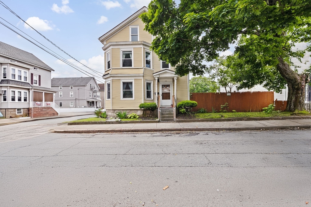 93 Warren Street Fall River, MA 02721 - Photo 38 of 42 a front view of a house with a yard and a garage