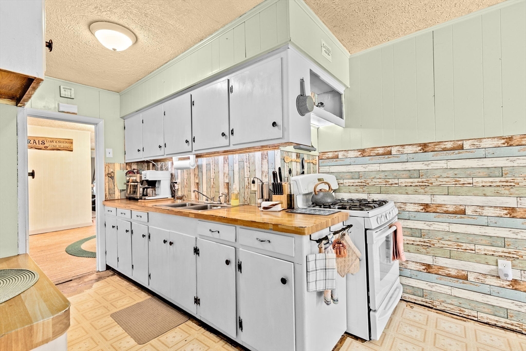93 Warren Street Fall River, MA 02721 - Photo 5 of 42 a kitchen with cabinets appliances a sink and a counter space
