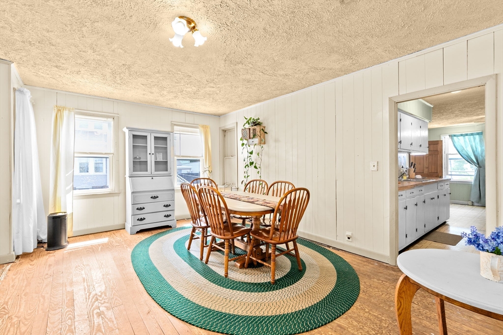 93 Warren Street Fall River, MA 02721 - Photo 10 of 42 a dining room with furniture a rug and wooden floor