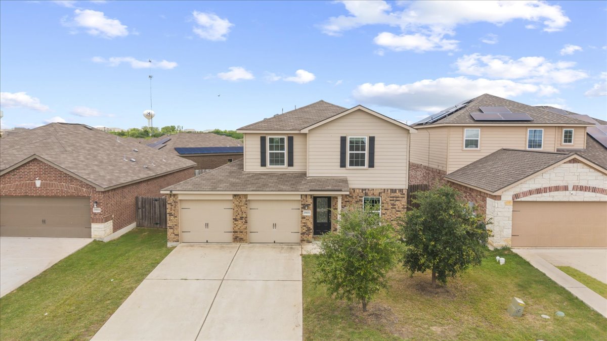19808 Hubert R Humphrey Road Manor, TX 78653 - Photo 13 of 37 A classic facade showcasing brick and siding, complemented by an integrated double garage.