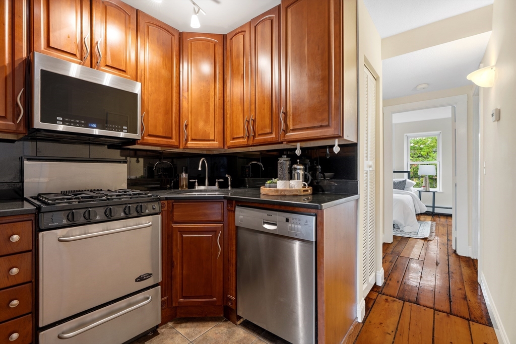 88 West Springfield Street, Unit 3 Boston, MA 02118 - Photo 10 of 17 a kitchen with granite countertop wooden cabinets and a stove top oven