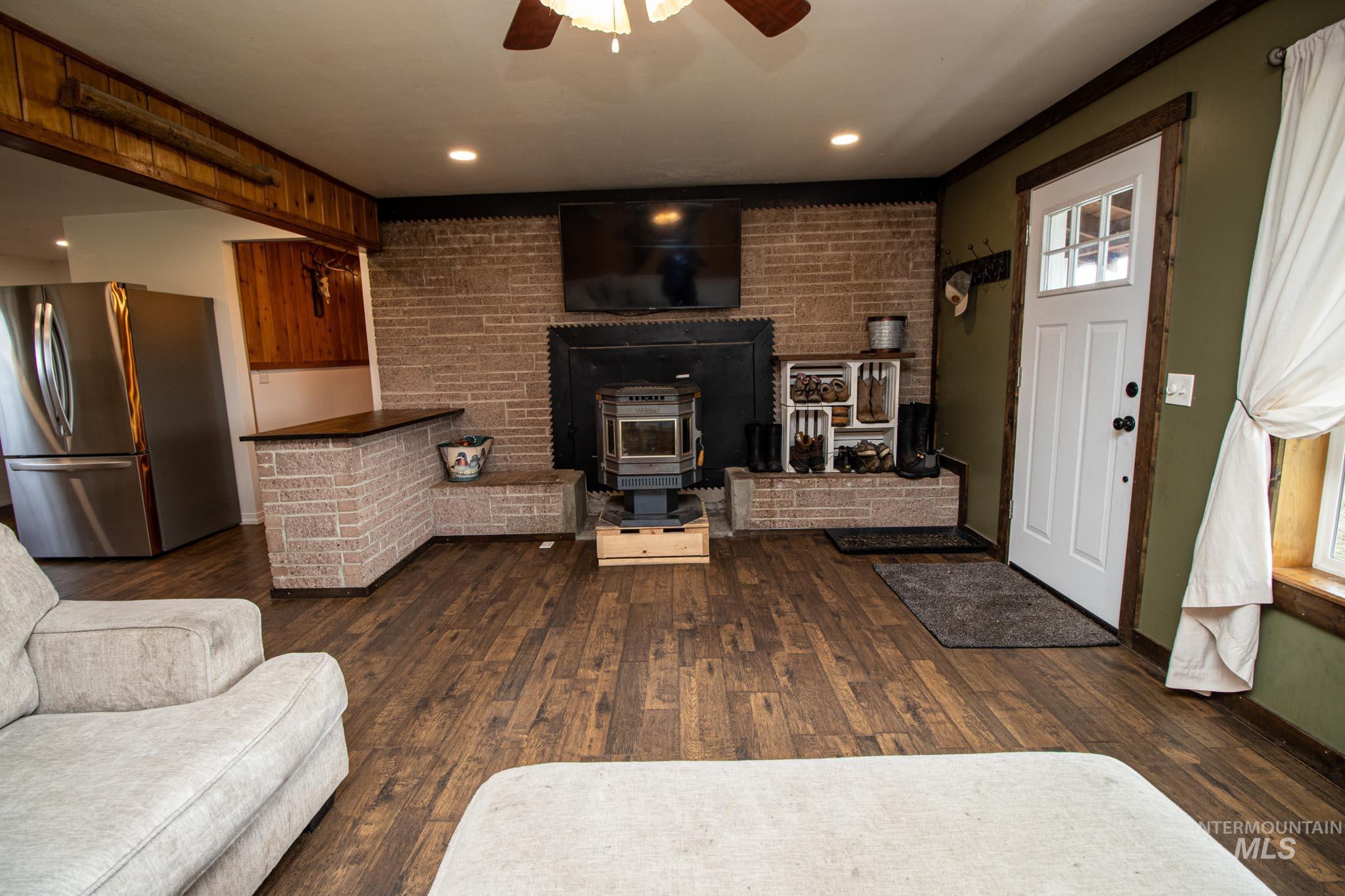 272 Cemetery Road Weippe, ID 83553 - Photo 14 of 43 Living room featuring a wood stove, a ceiling fan, dark wood-type flooring, and recessed lighting