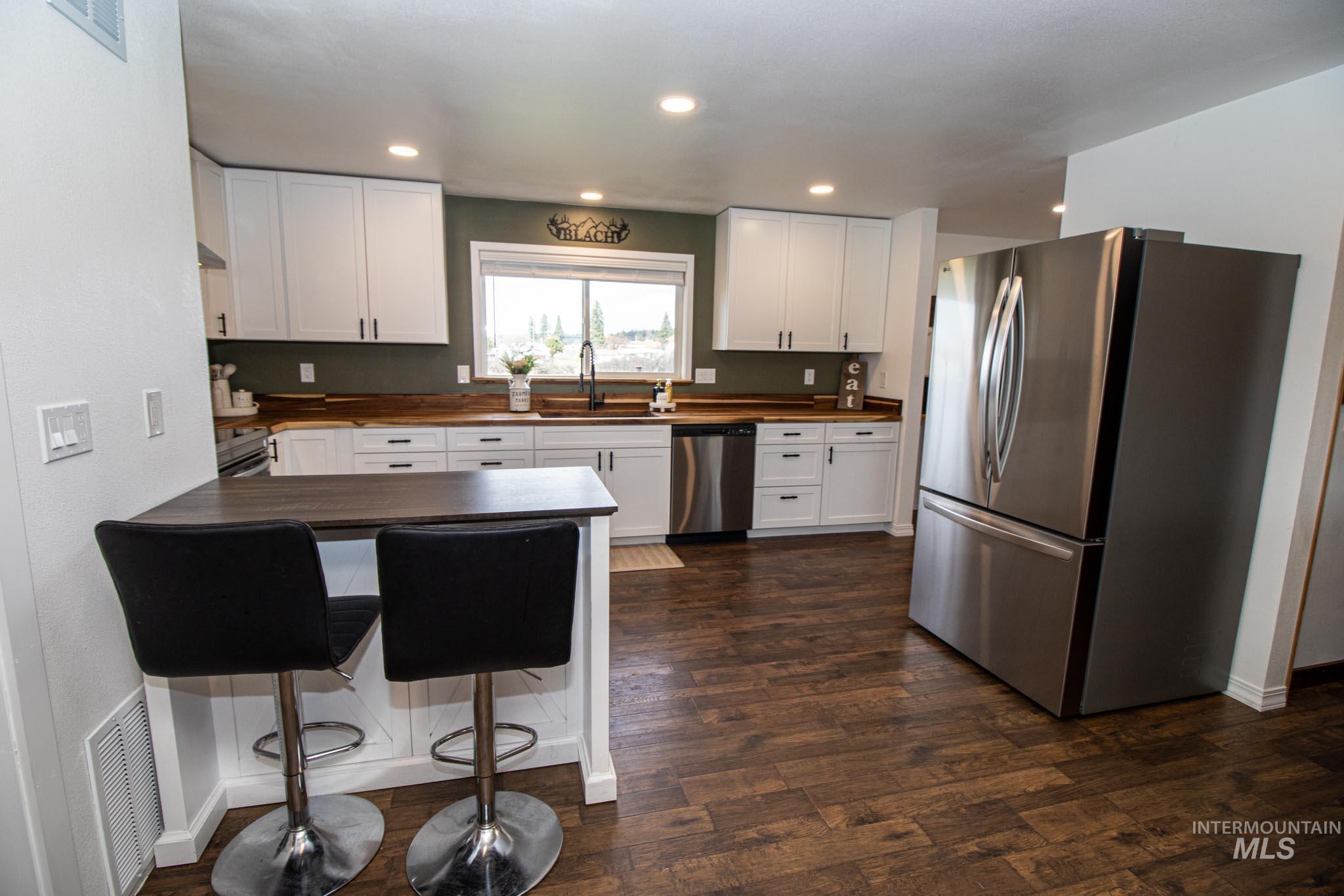 272 Cemetery Road Weippe, ID 83553 - Photo 15 of 43 Kitchen featuring stainless steel appliances, white cabinets, wood counters, and recessed lighting