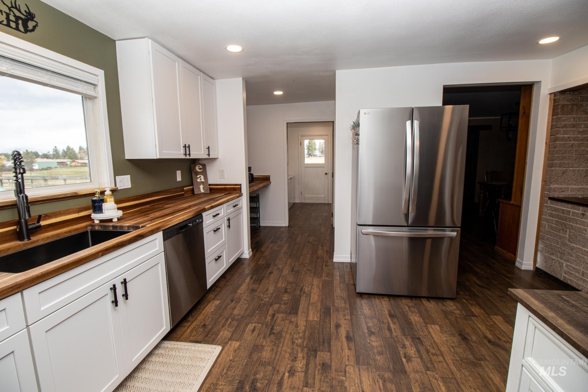 272 Cemetery Road Weippe, ID 83553 - Photo 18 of 43 Kitchen featuring wooden counters, stainless steel appliances, white cabinetry, dark wood finished floors, and recessed lighting