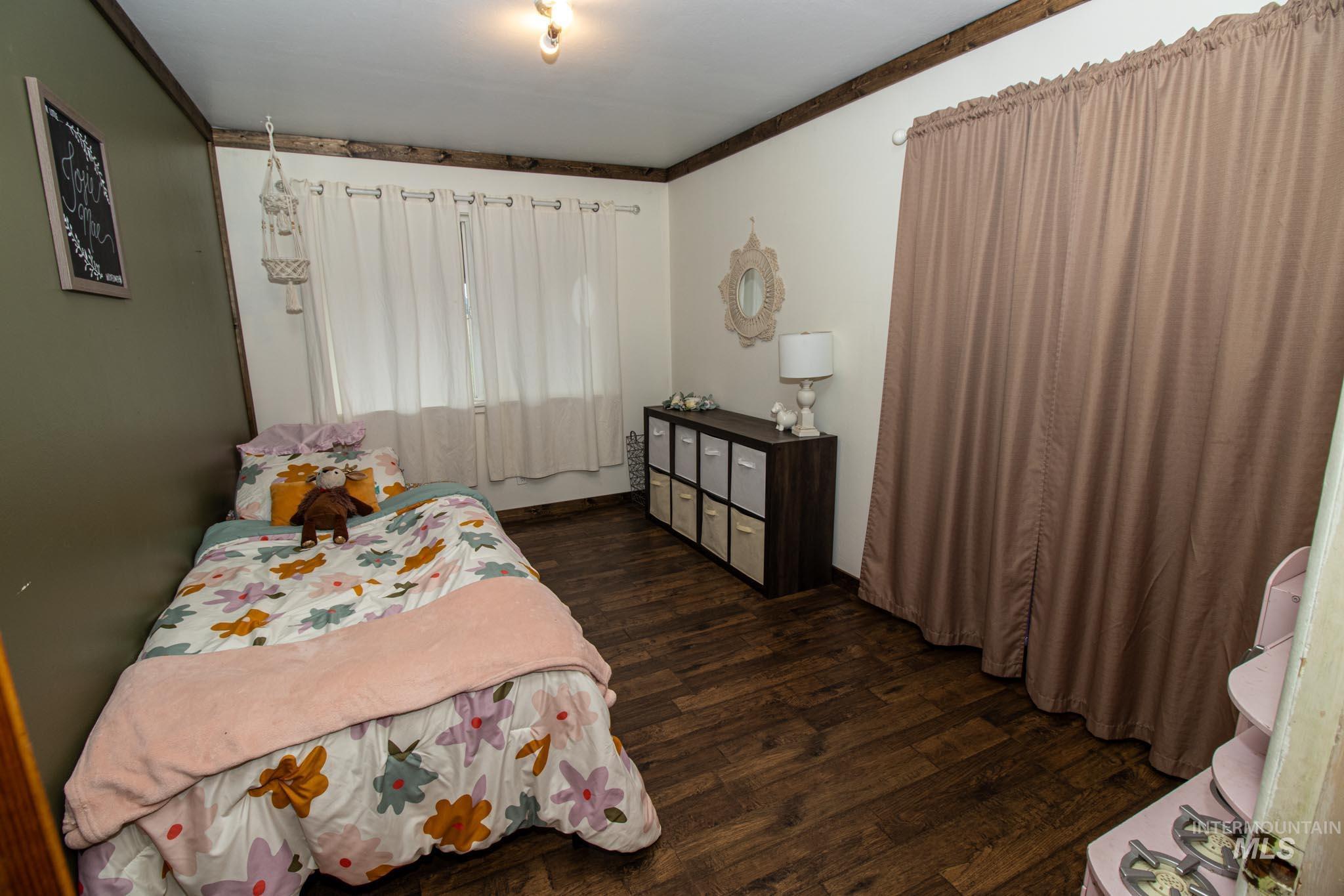 272 Cemetery Road Weippe, ID 83553 - Photo 28 of 43 Bedroom with dark wood-style floors and crown molding
