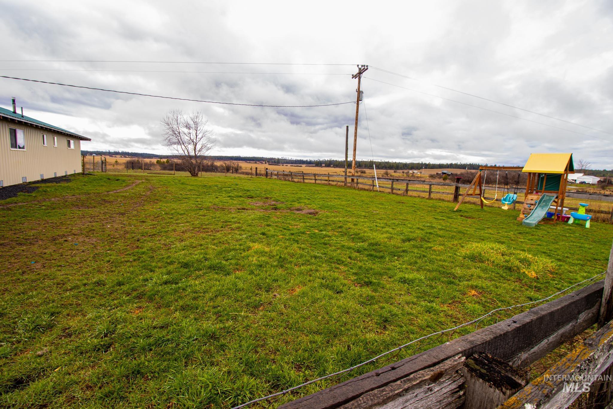 272 Cemetery Road Weippe, ID 83553 - Photo 34 of 43 Fenced backyard featuring a playground and a view of rural / pastoral area