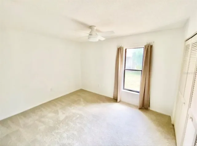 an empty room with windows and closet
