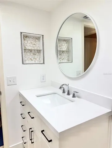 a bathroom with a sink and mirror