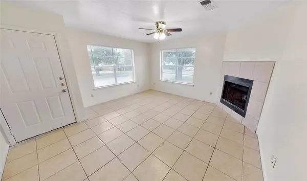 a view of empty room with window and fireplace