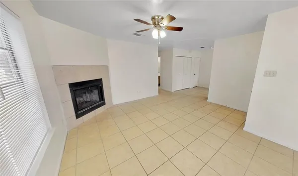 a view of empty room with a fireplace