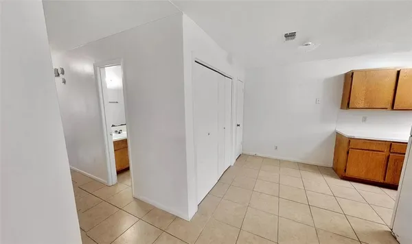 a view of kitchen with a sink cabinet and a mirror