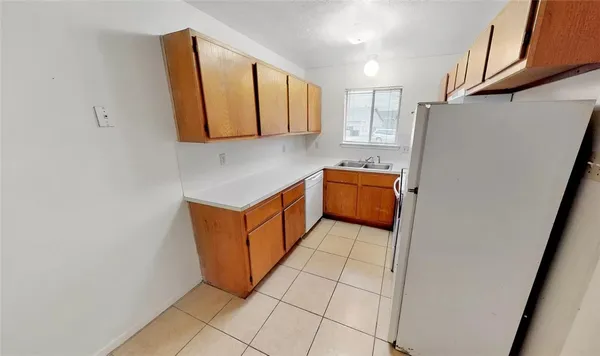 a kitchen with stainless steel appliances granite countertop a refrigerator and a stove