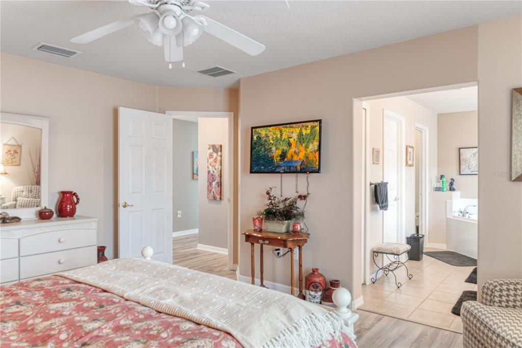 4925 Poolside Drive St. Cloud, FL 34769 - Photo 17 of 36 a bedroom with a bed and a chandelier