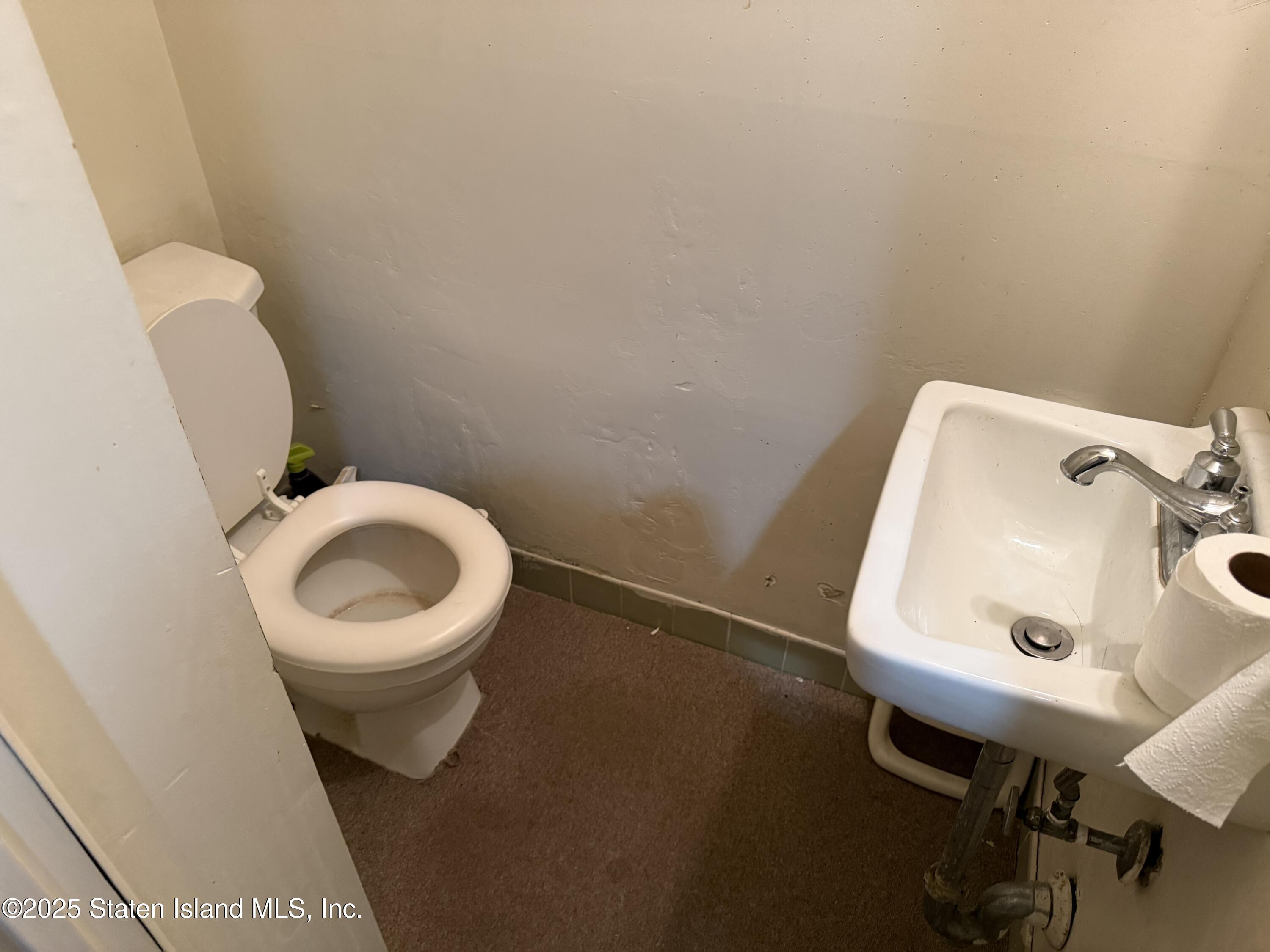 89 Kenmore Street Staten Island, NY 10312 - Photo 16 of 18 a bathroom with a toilet and a sink