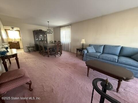 89 Kenmore Street Staten Island, NY 10312 - Photo 5 of 18 a living room with furniture and a chandelier