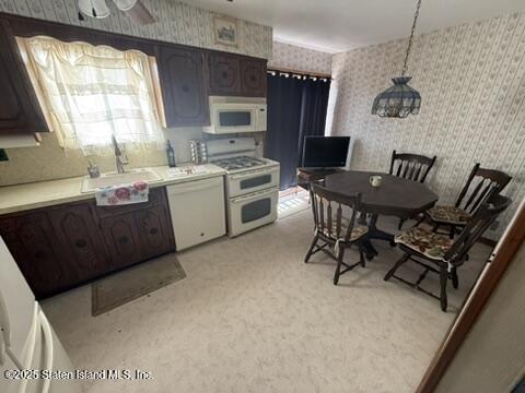 89 Kenmore Street Staten Island, NY 10312 - Photo 8 of 18 a kitchen with a table chairs sink and cabinets