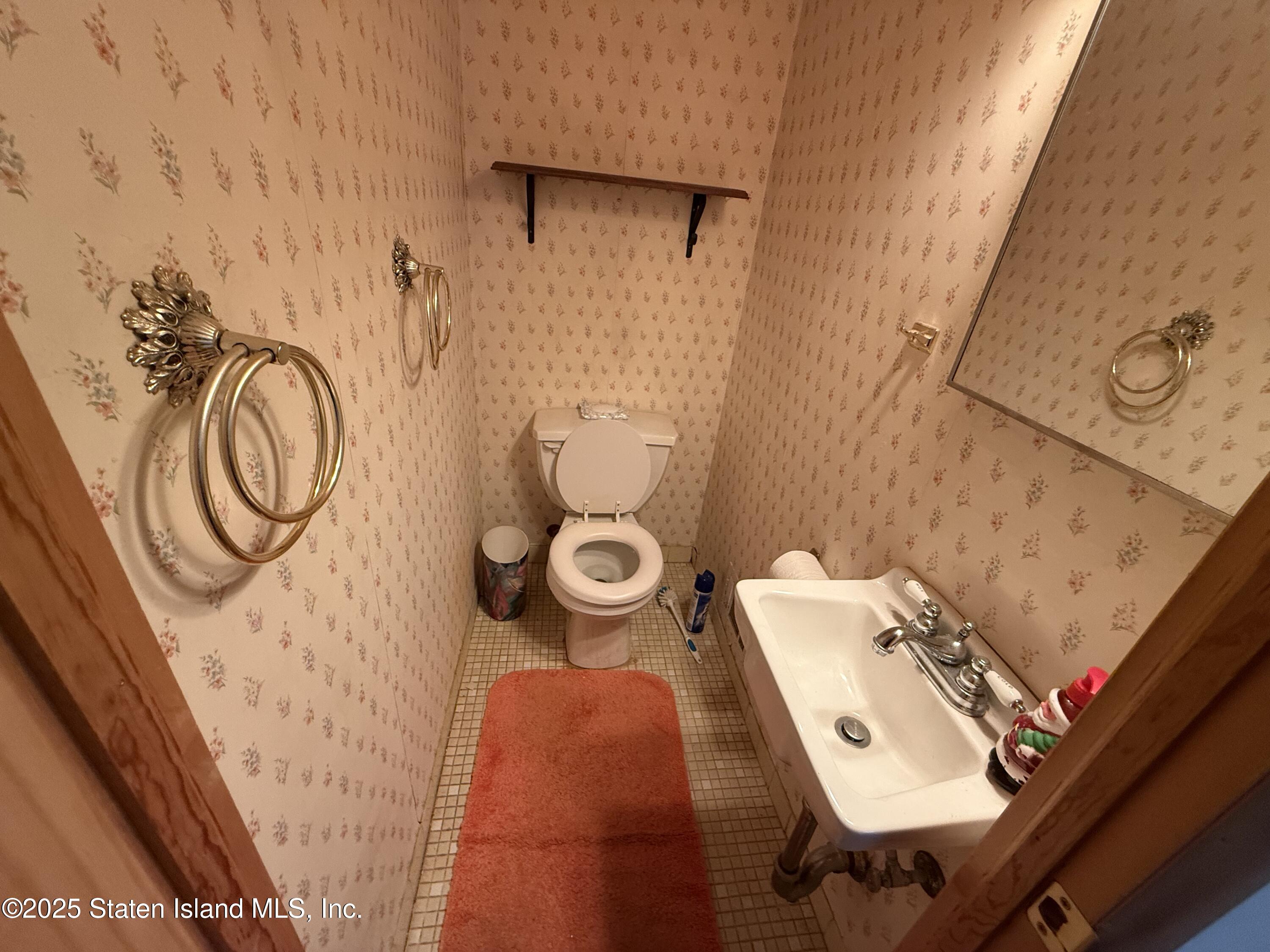 89 Kenmore Street Staten Island, NY 10312 - Photo 9 of 18 a bathroom with a sink toilet and shower curtain