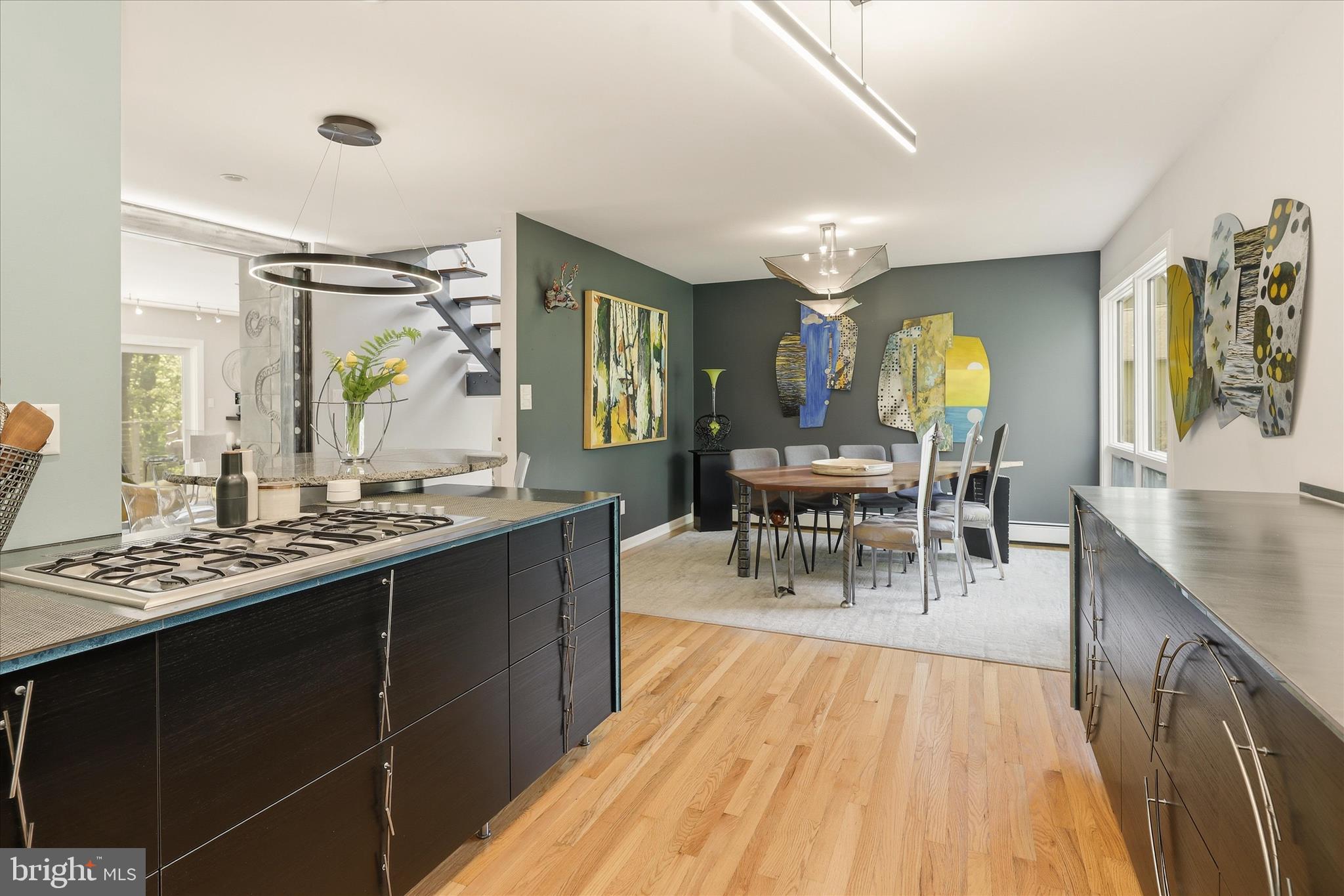 927 Buckhorn Road Sykesville, MD 21784 - Photo 25 of 147 a dining hall with stainless steel appliances granite countertop a stove top oven a dining table and chairs with wooden floor