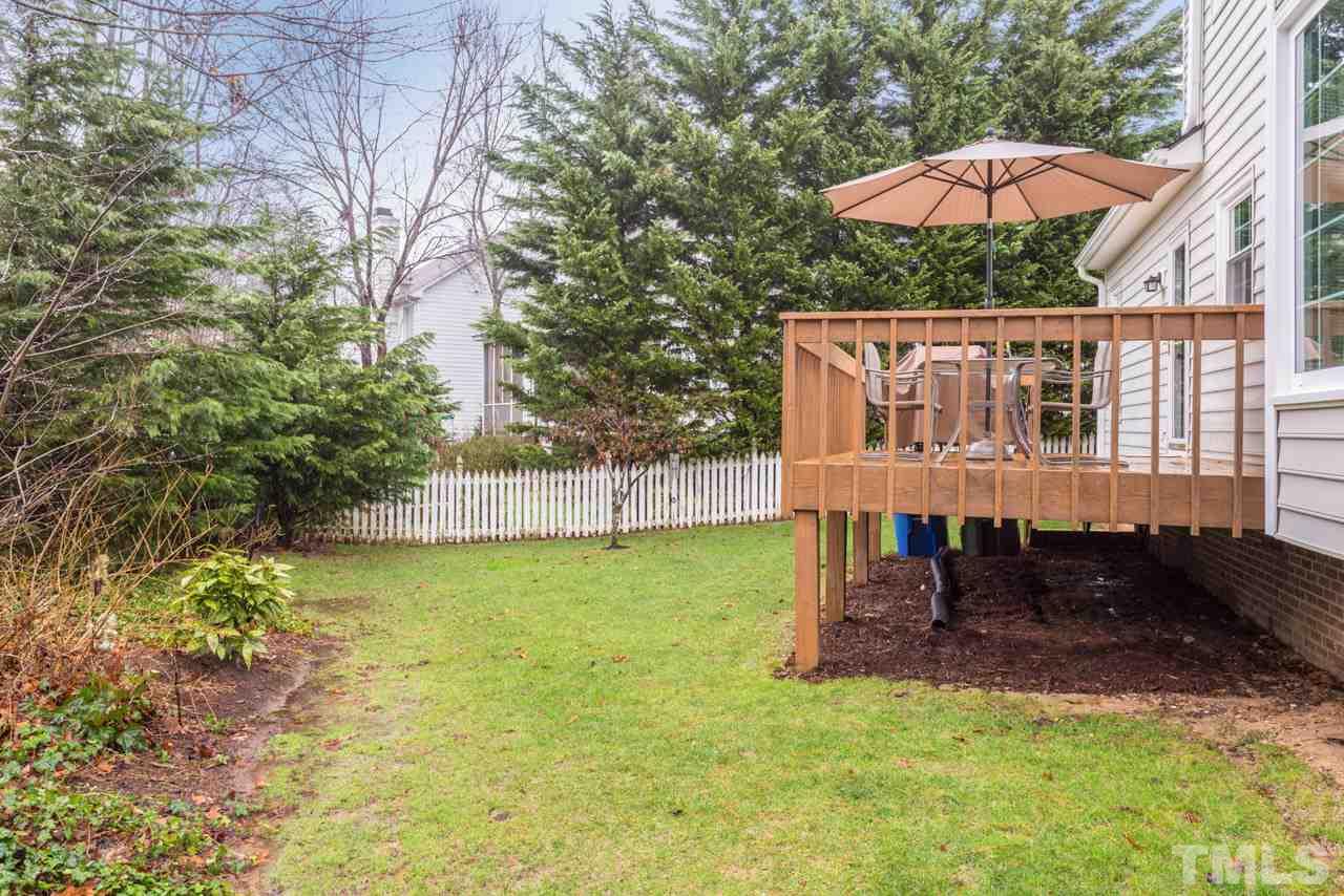 5409 Ingate Way Raleigh, NC 27613 - Photo 22 of 25 Great backyard for fun and games! Lovely evergreens provide privacy.