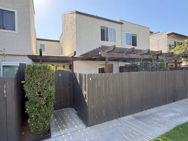 a view of a house with a backyard and plants