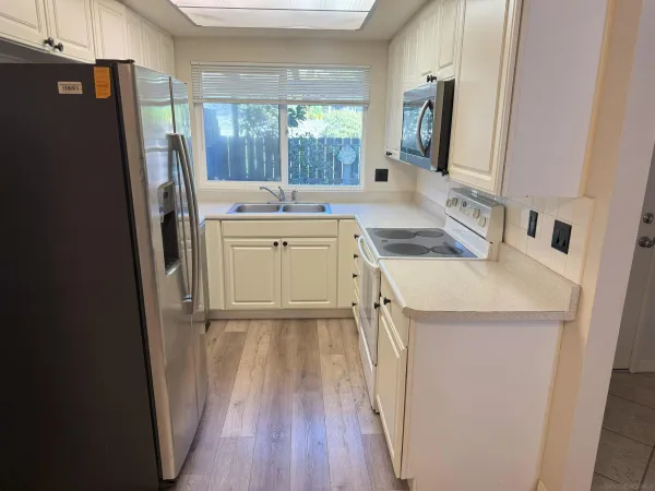 a kitchen with a sink a refrigerator a washer and dryer