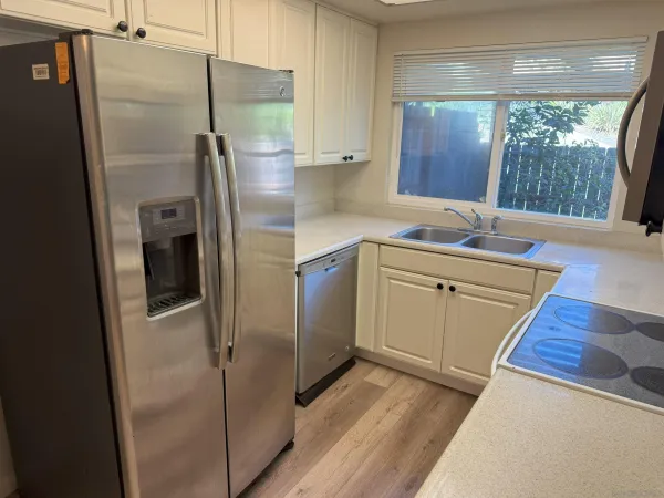 a kitchen with stainless steel appliances a refrigerator sink and cabinets