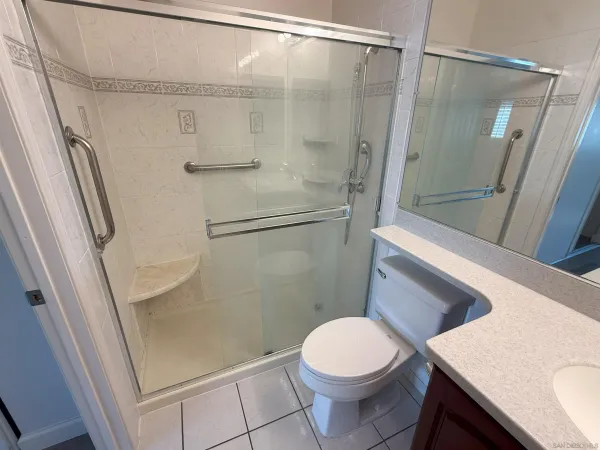 a bathroom with a toilet and a shower