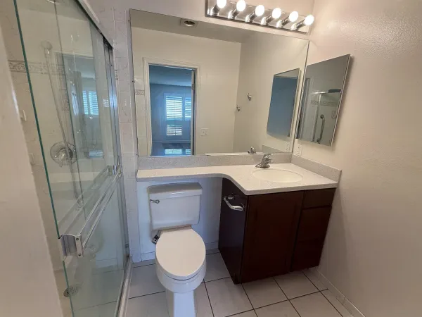 a bathroom with a sink vanity and toilet