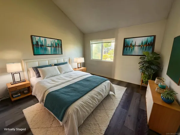 a bedroom with a bed and a potted plant
