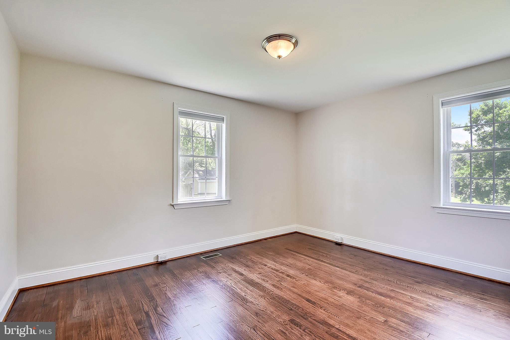 13039 Beaver Dam Road Cockeysville, MD 21030 - Photo 12 of 20 an empty room with wooden floor and windows