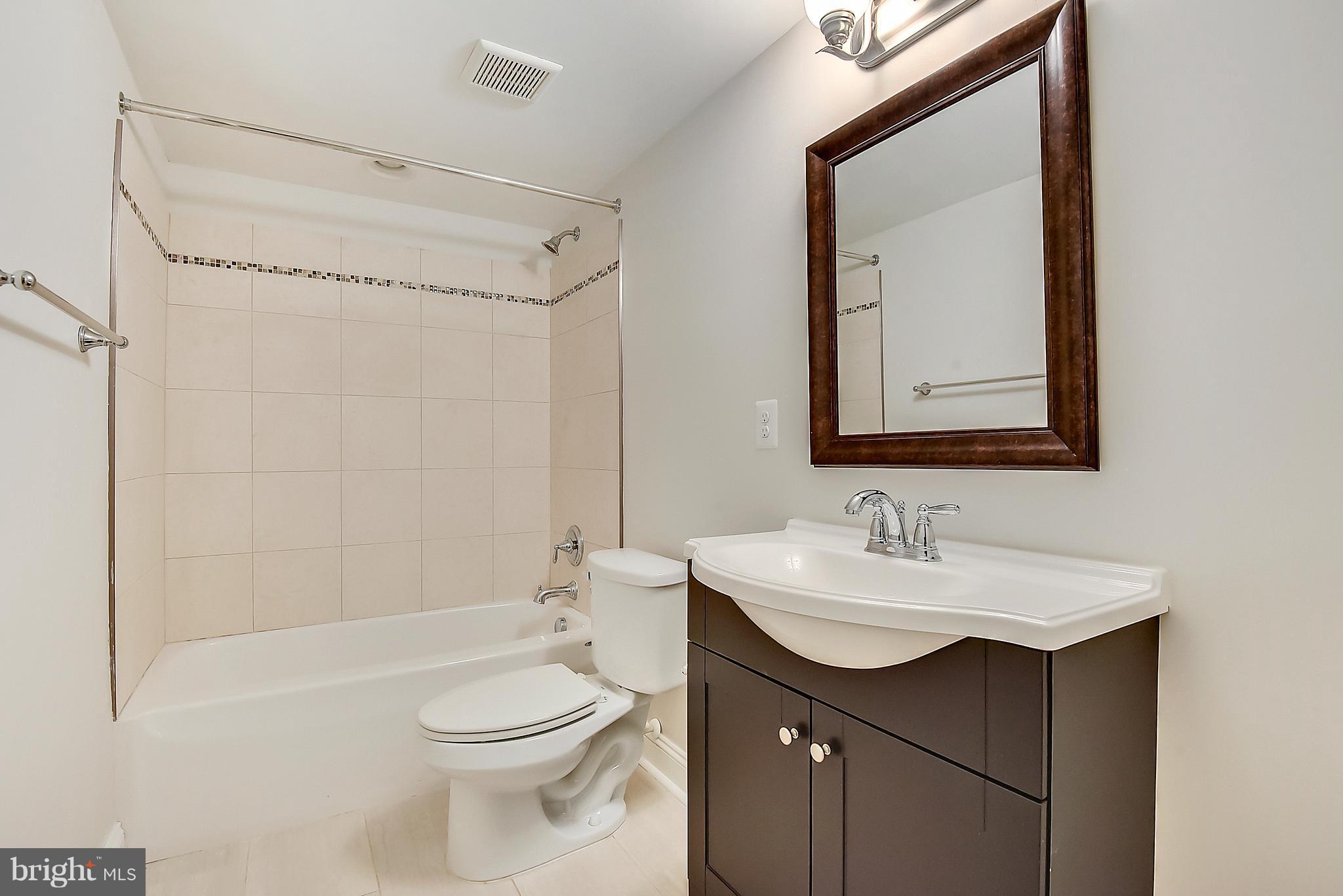 13039 Beaver Dam Road Cockeysville, MD 21030 - Photo 13 of 20 a bathroom with a sink a toilet and shower