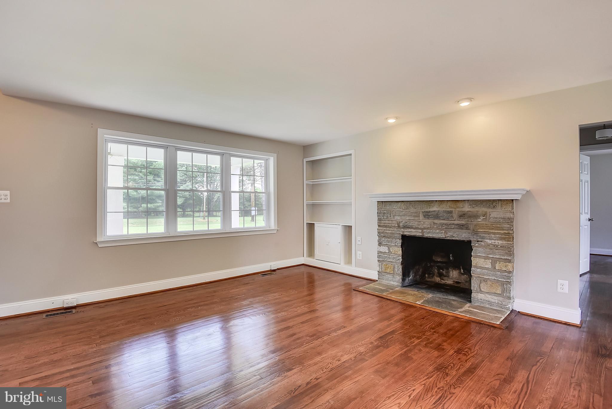 13039 Beaver Dam Road Cockeysville, MD 21030 - Photo 5 of 20 a living room with a fireplace and wooden floor