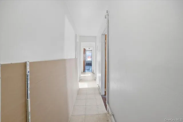 a bedroom with a bed and a refrigerator