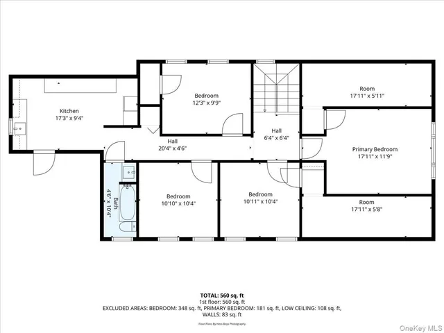 a picture of a bench in front of a wall