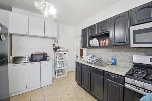 a kitchen with a stove top oven and cabinets