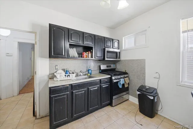 a kitchen with refrigerator and chairs