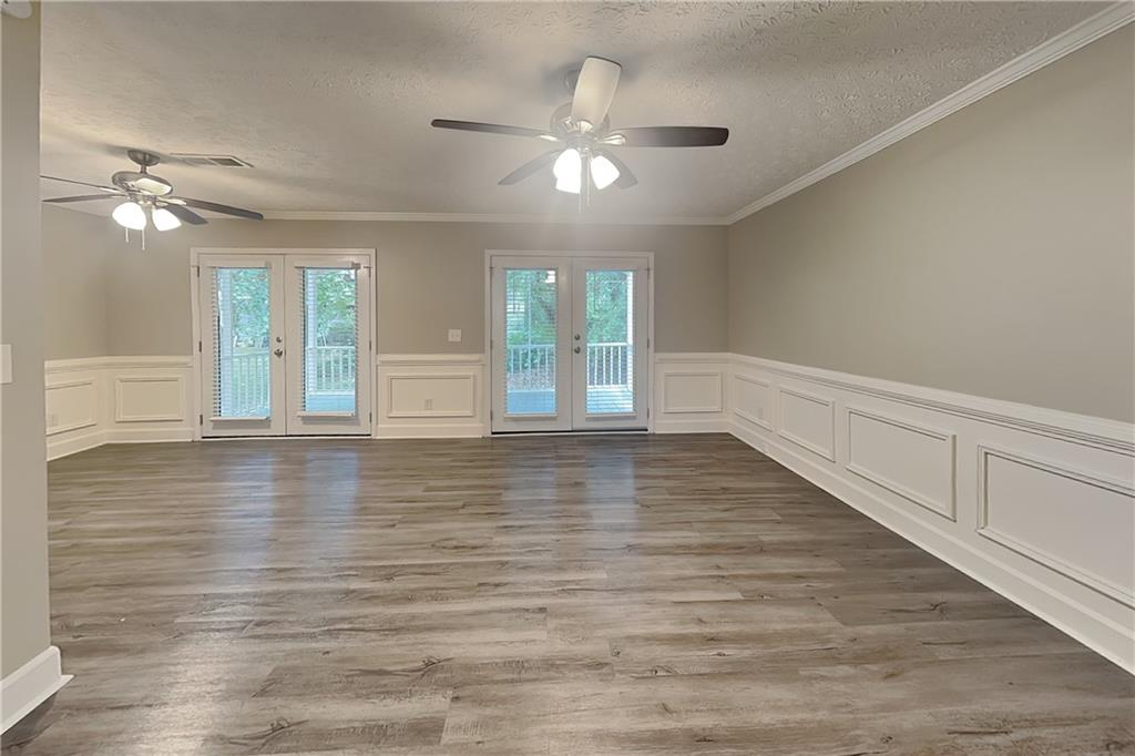 335 Olde Bridge Way Johns Creek, GA 30022 - Photo 3 of 19 wooden floor in an empty room with a window