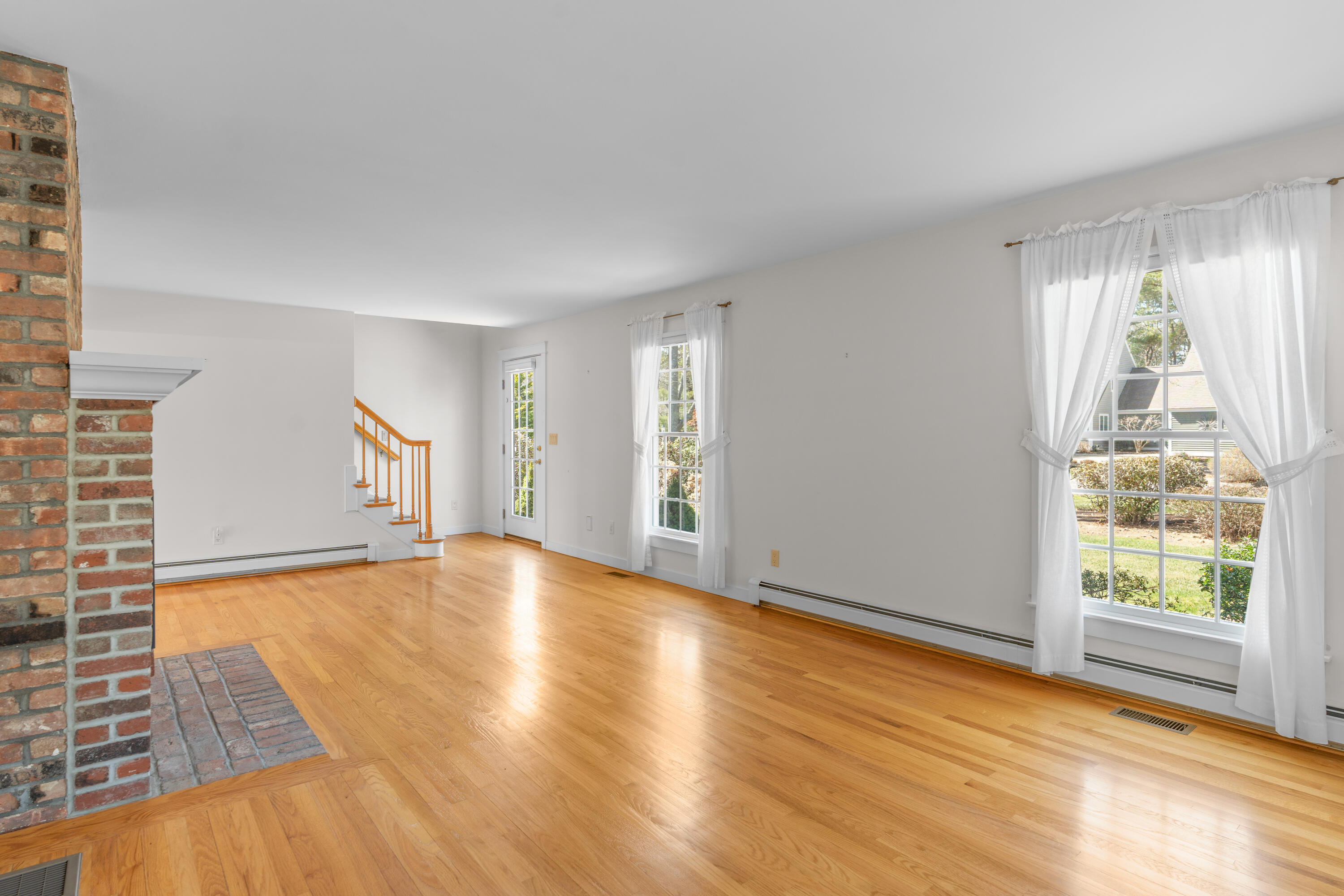 51 Walton Heath Way Mashpee, MA 02649 - Photo 12 of 35 an empty room with wooden floor and windows