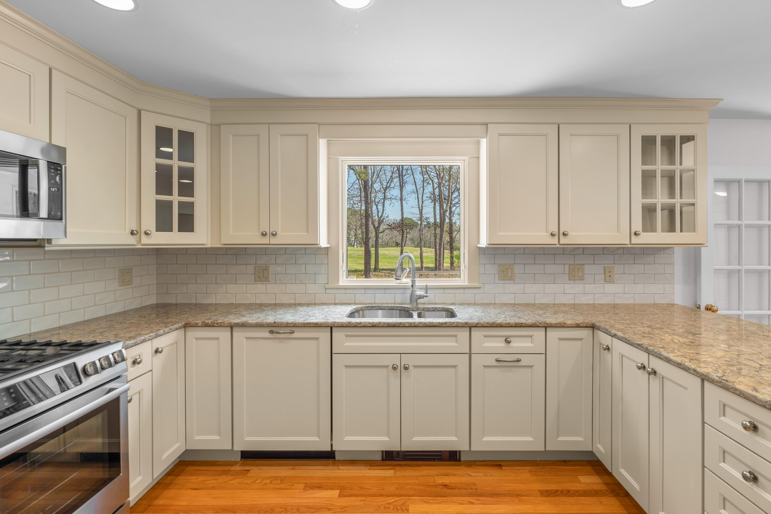51 Walton Heath Way Mashpee, MA 02649 - Photo 3 of 35 a kitchen with a sink stove and cabinets