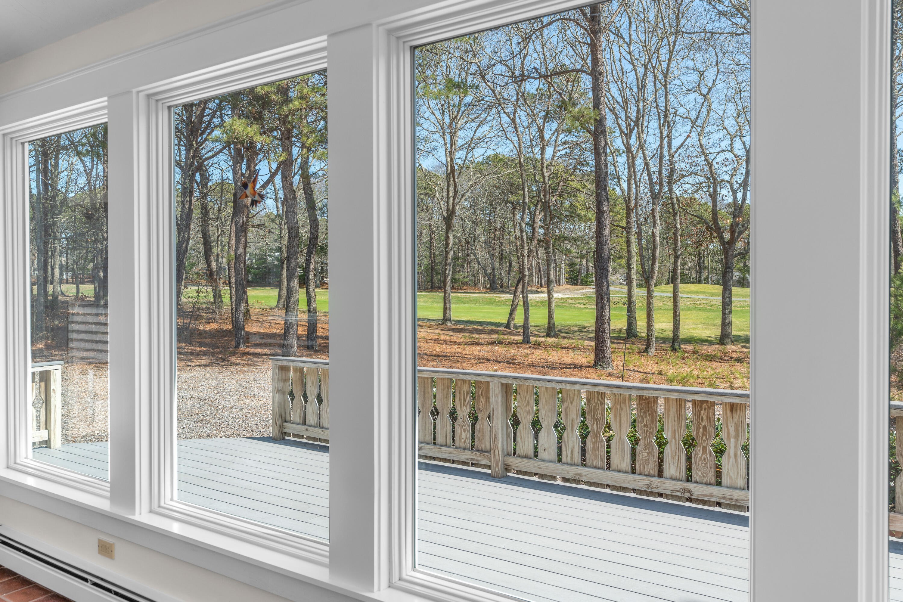 51 Walton Heath Way Mashpee, MA 02649 - Photo 9 of 35 a view of a wooden balcony with a floor to ceiling window