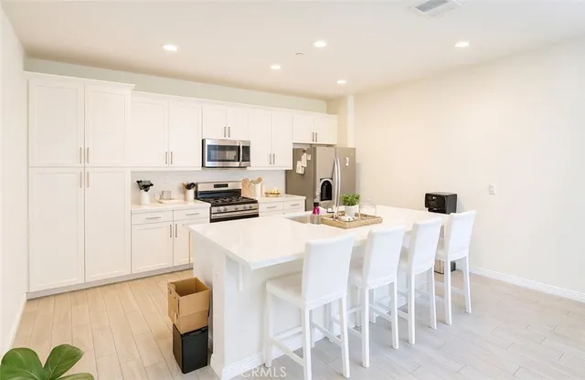 a kitchen with a sink cabinets and wooden floor