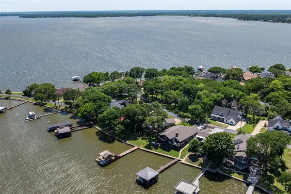 an aerial view of a houses with a lake view