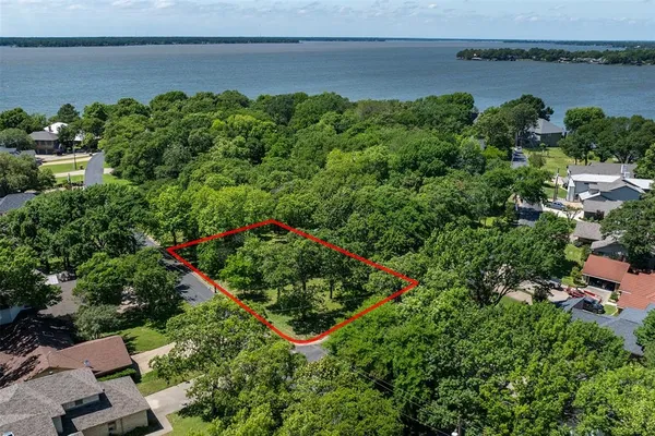 an aerial view of a house with a yard and lake view