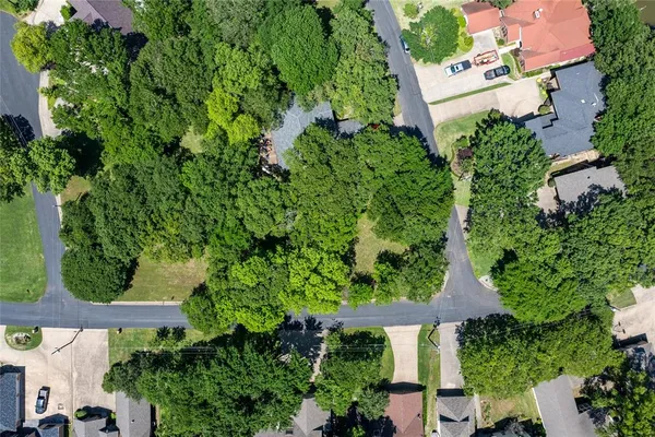 an aerial view of residential house with outdoor space and trees all around