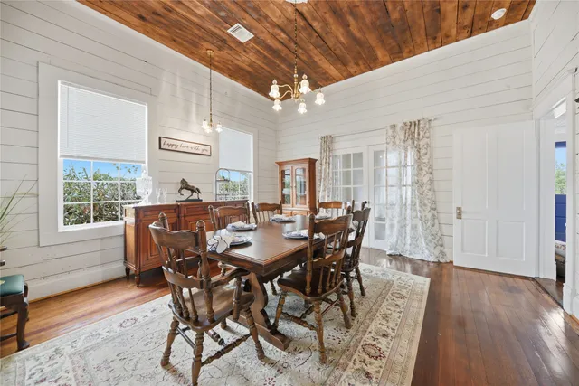 a dining room with furniture window and wooden floor