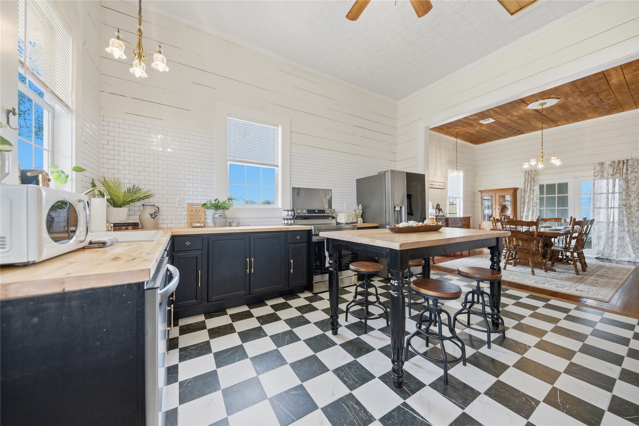 511 Peabody Street Brenham, TX 77833 - Photo 8 of 25 a kitchen with a dining table chairs and white appliances