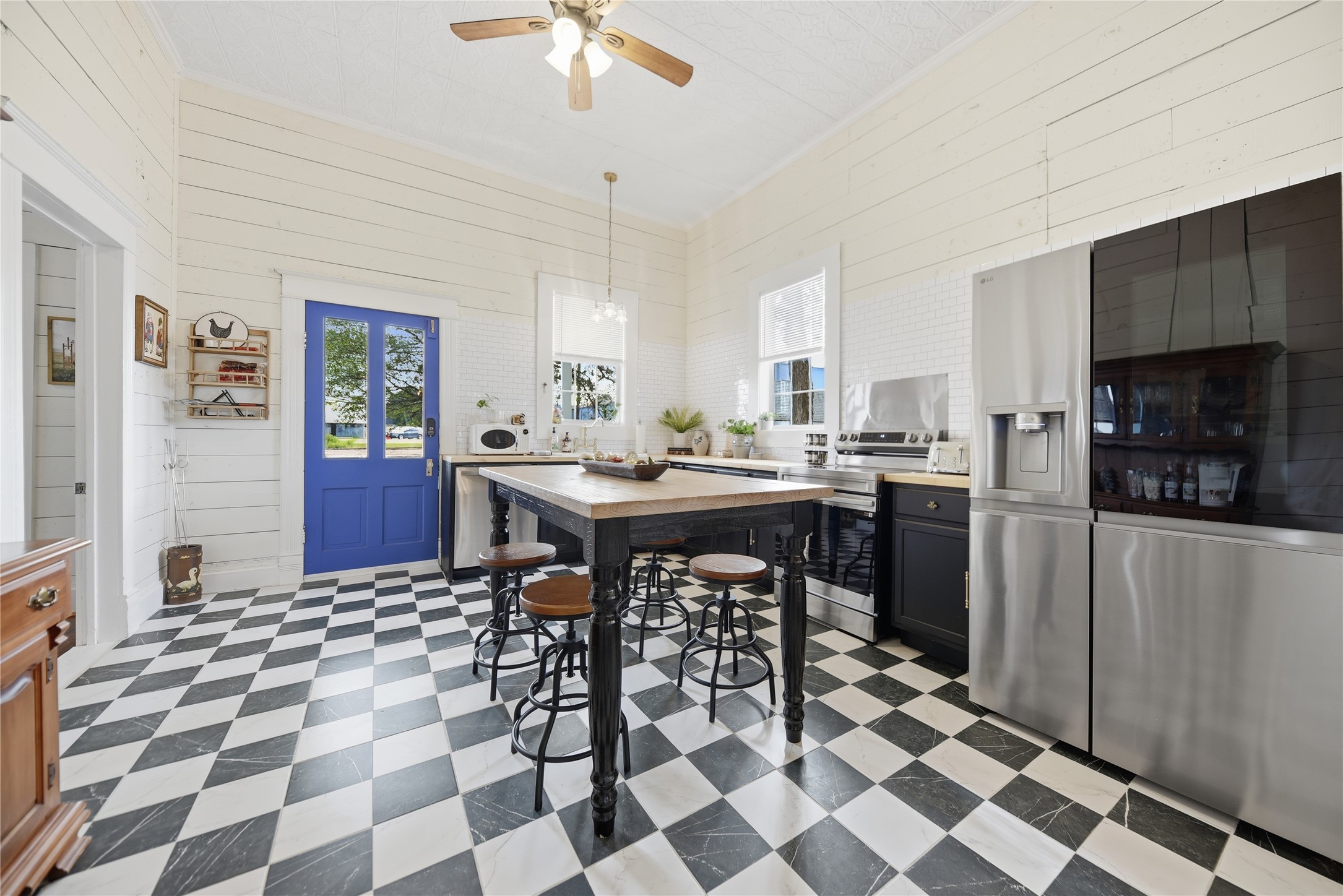 511 Peabody Street Brenham, TX 77833 - Photo 9 of 25 a kitchen with a sink a counter and dining table chairs