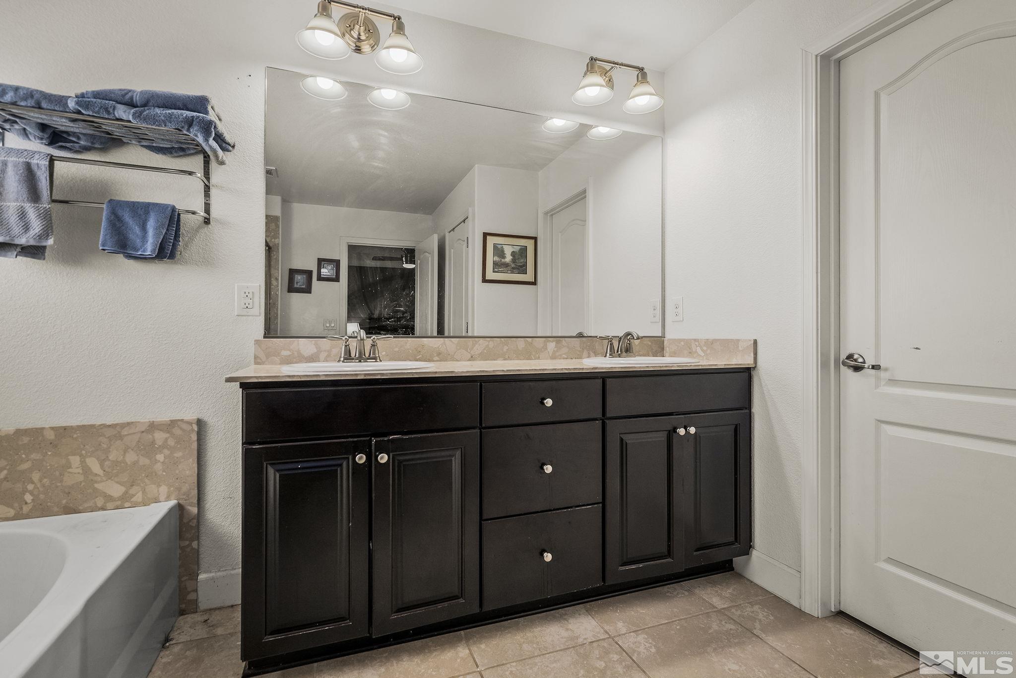 7707 Rhythm Circle Sparks, NV 89436 - Photo 14 of 25 a bathroom with a sink double vanity and a mirror